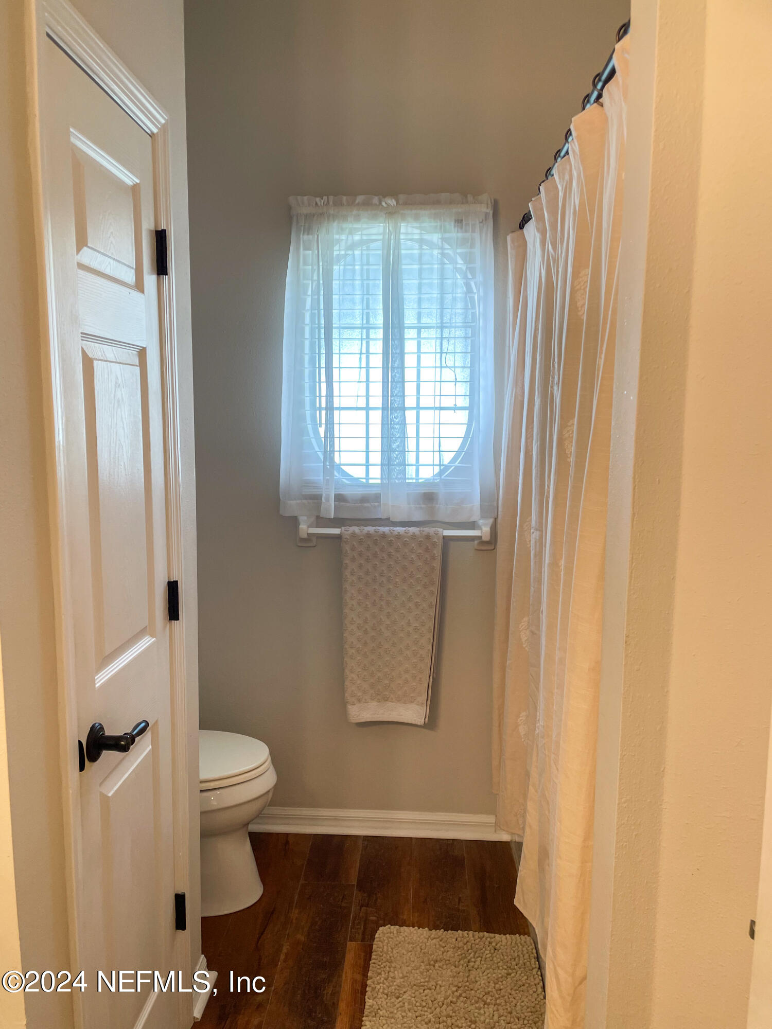 112 Eberhard Avenue Palatka, FL 32177 - Photo 47 of 48 a bathroom with a toilet and a shower curtain