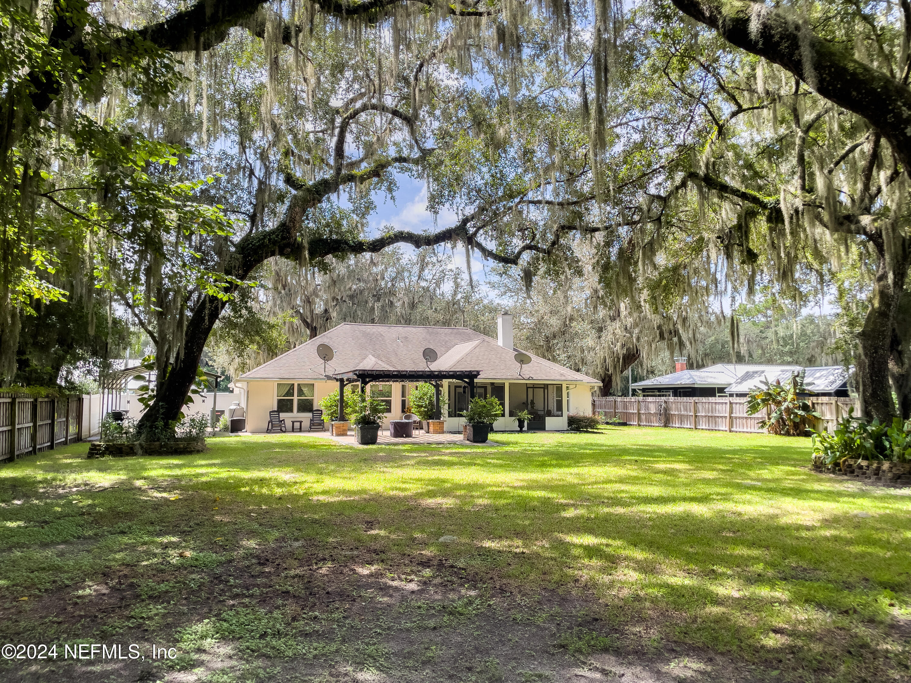 112 Eberhard Avenue Palatka, FL 32177 - Photo 7 of 48 a view of a house with a big yard and large trees