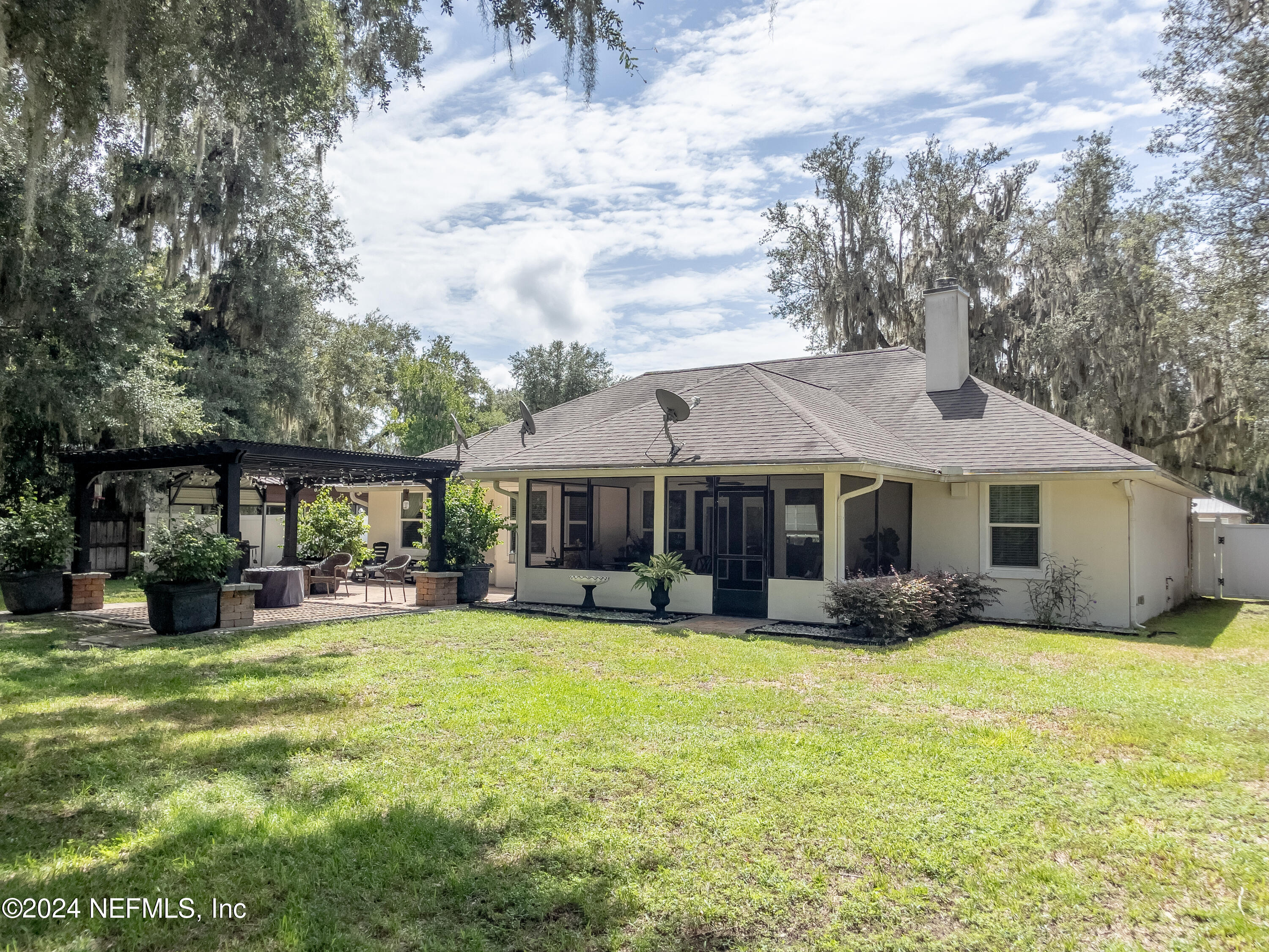 112 Eberhard Avenue Palatka, FL 32177 - Photo 8 of 48 a front view of a house with a yard and trees