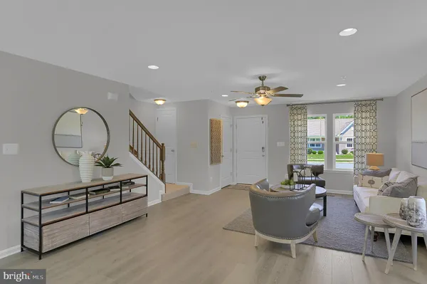 a living room with furniture a window and a chandelier