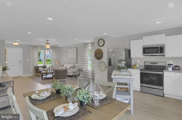a living room with furniture kitchen view and a fireplace