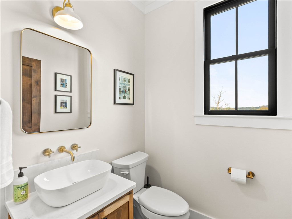 331 Bakerville Road Easley, SC 29642 - Photo 16 of 43 This serene bathroom offers a sophisticated vessel sink and a clear window with outdoor views.