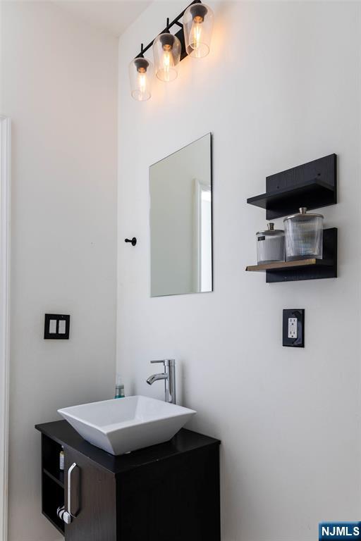 126 Ridge Avenue Bloomfield, NJ 07003 - Photo 16 of 45 a bathroom with a sink and a mirror