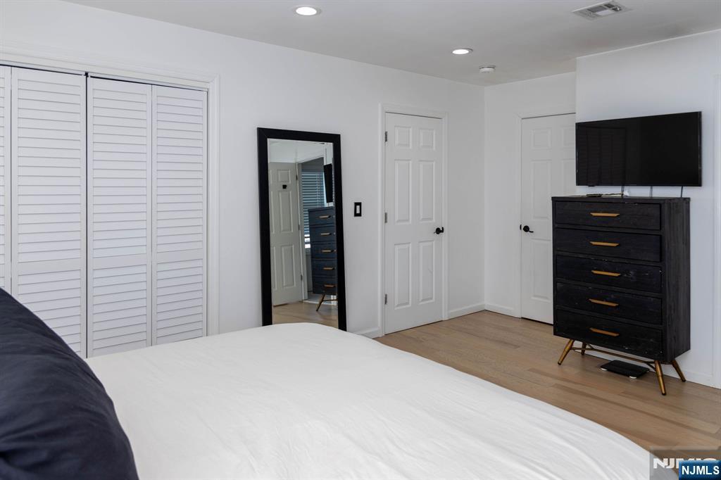 126 Ridge Avenue Bloomfield, NJ 07003 - Photo 21 of 45 a bedroom with a bed and a flat tv screen