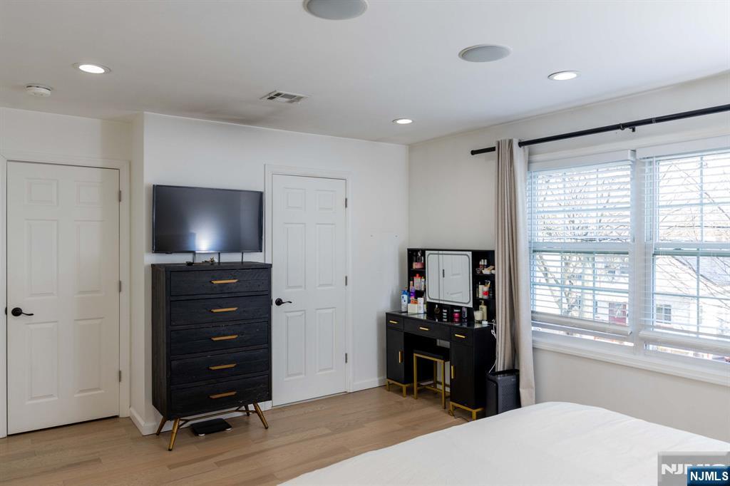 126 Ridge Avenue Bloomfield, NJ 07003 - Photo 22 of 45 a room with a bed and a flat tv screen