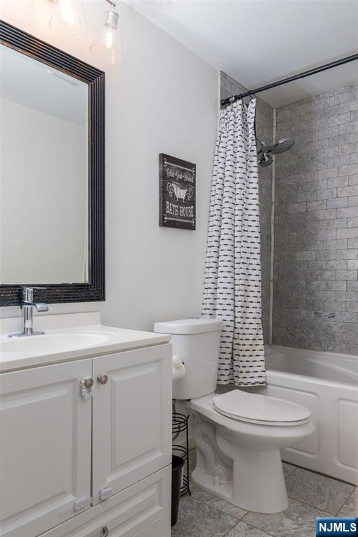 126 Ridge Avenue Bloomfield, NJ 07003 - Photo 26 of 45 a bathroom with a white toilet sitting next to a bathroom sink
