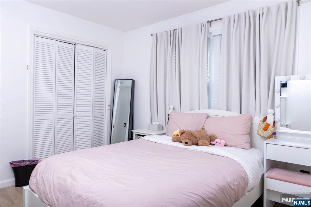 126 Ridge Avenue Bloomfield, NJ 07003 - Photo 28 of 45 a bedroom with a bed and a table