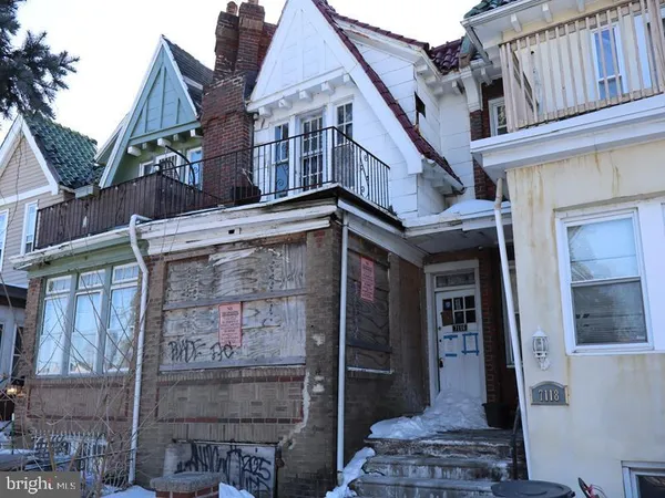 a view of a house with brick walls