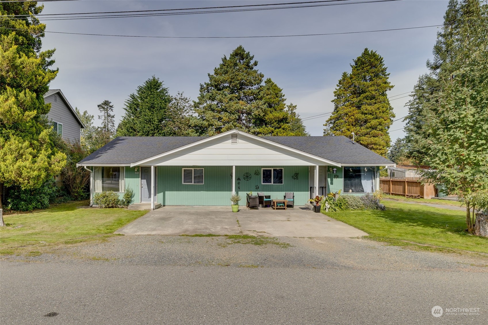 a view of a house with a yard and large tree