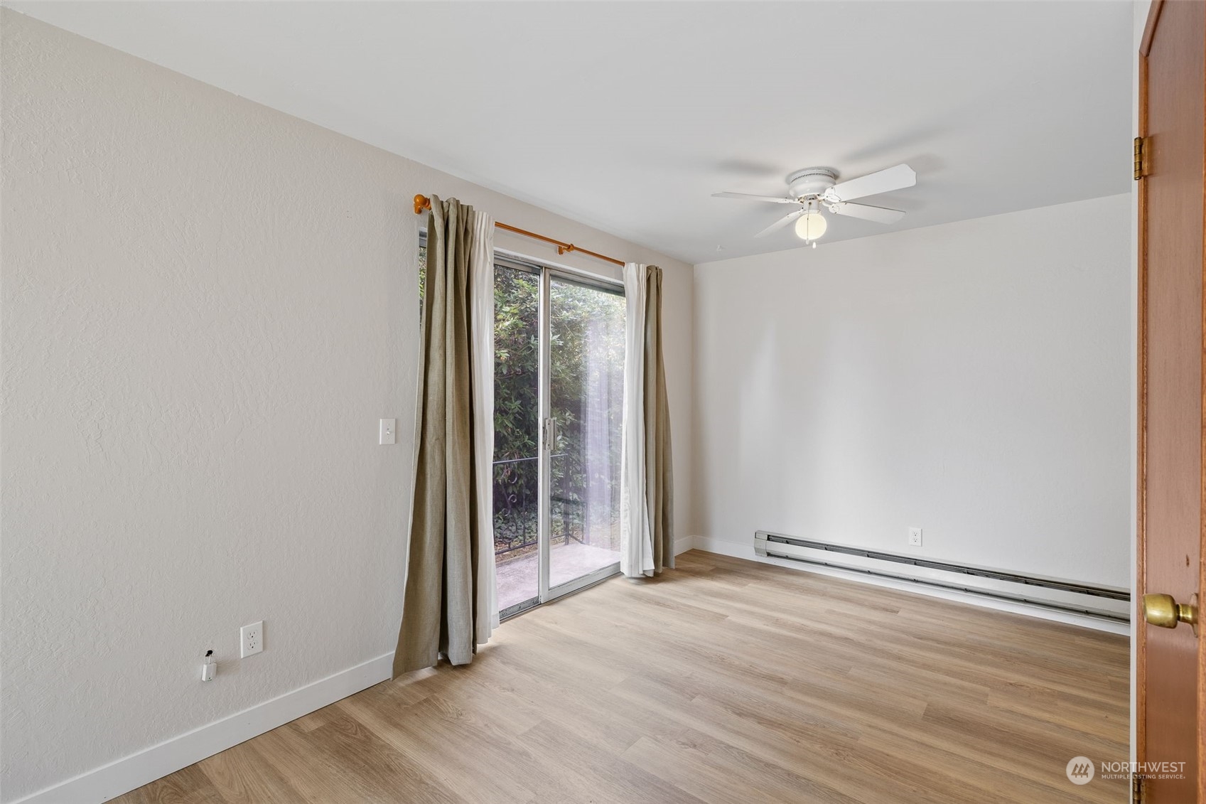 17 Fern Road Everett, WA 98203 - Photo 7 of 24 an empty room with wooden floor fan and windows