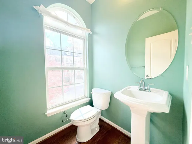 a bathroom with a sink toilet and mirror