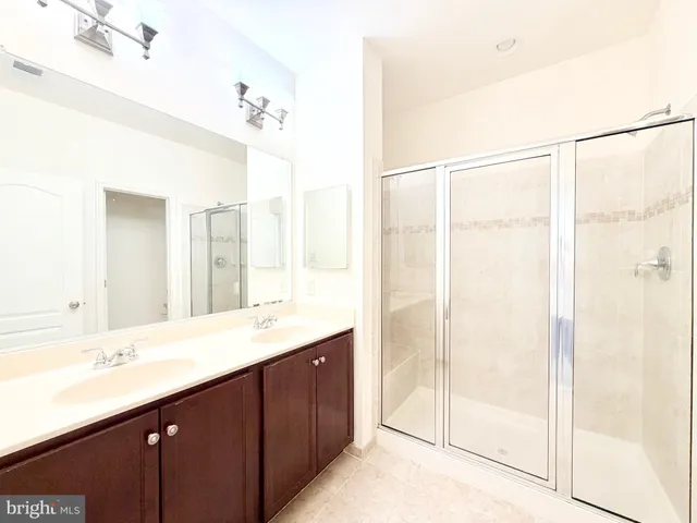 a bathroom with a double vanity sink and mirror