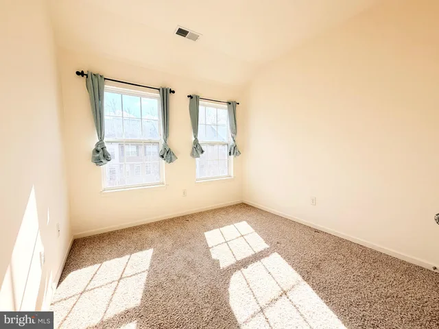 a living room with furniture a rug and a window