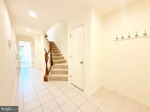 a view of a room with white walls and stairs