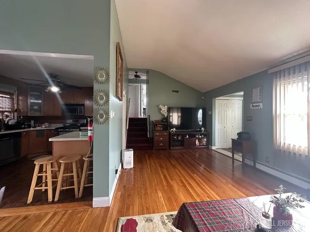 a living room with furniture and a wooden floor