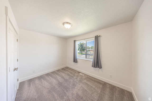 4991 South 475 West Washington Terrace, UT 84405 - Photo 26 of 31 Bedroom #3. Light wall color. Light carpet. Natural light through window.