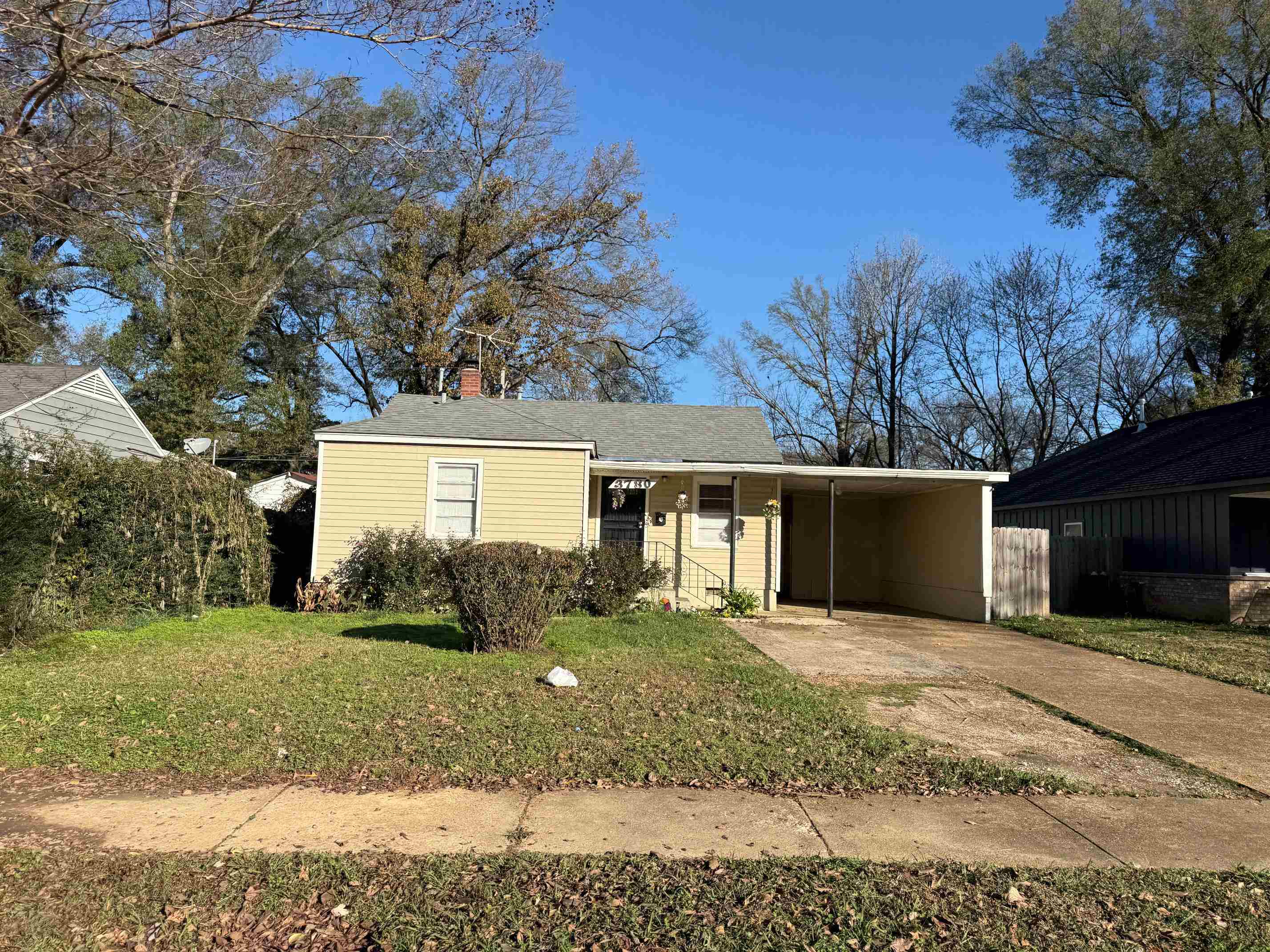 3780 Mallory Road Memphis, TN 38111 - Photo 1 of 1 View of front of house with a front lawn, concrete driveway, a chimney, and a carport