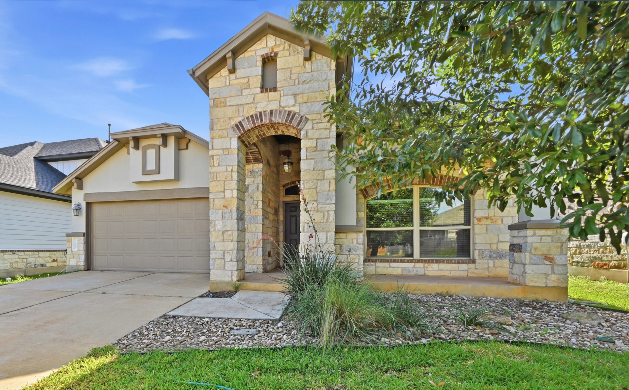 13009 Olivers Way Manchaca, TX 78652 - Photo 5 of 37 a front view of a house with garden
