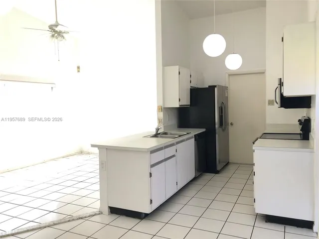 a kitchen with a sink cabinets and appliances