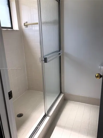 a bathroom with a glass shower door