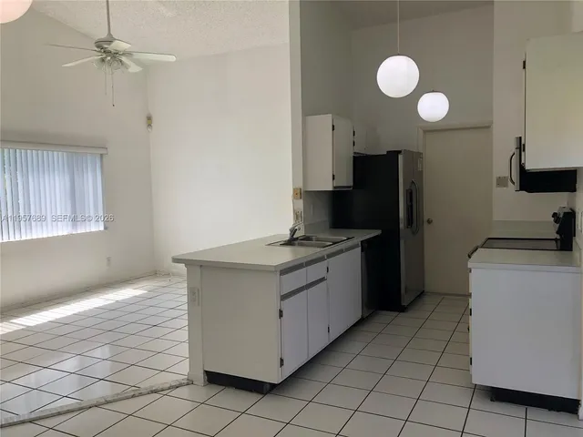 a kitchen with a sink cabinets and stainless steel appliances