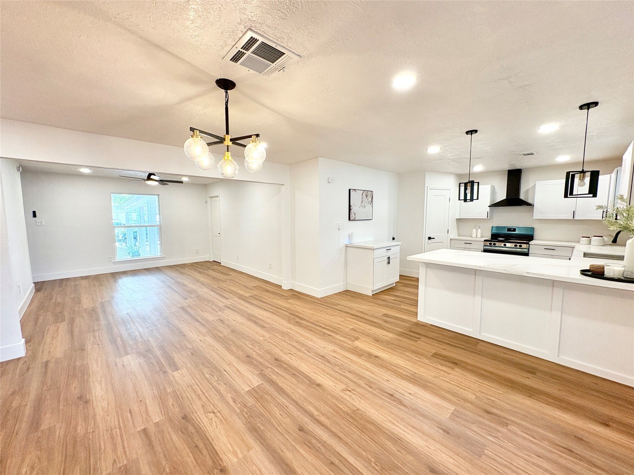 3726 Heatherbrook Drive Houston, TX 77045 - Photo 6 of 17 a large kitchen with cabinets wooden floor and stainless steel appliances