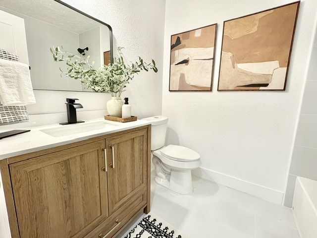 3726 Heatherbrook Drive Houston, TX 77045 - Photo 8 of 17 a bathroom with a sink a toilet and mirror