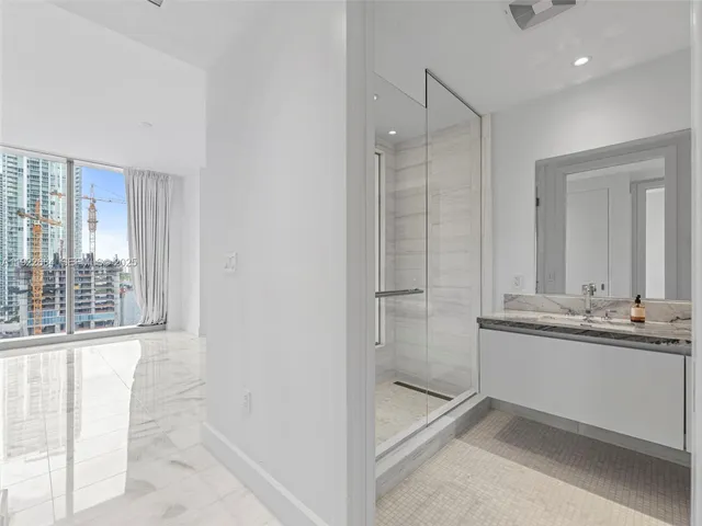 a bathroom with a tub sink and mirror