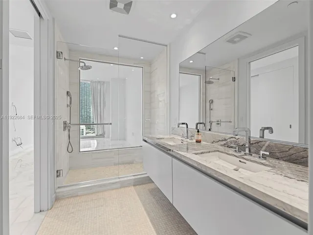 a bathroom with a granite countertop sink mirror and a bath tub