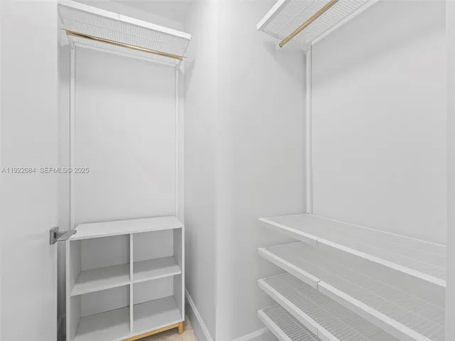 a view of walk in closet with empty racks