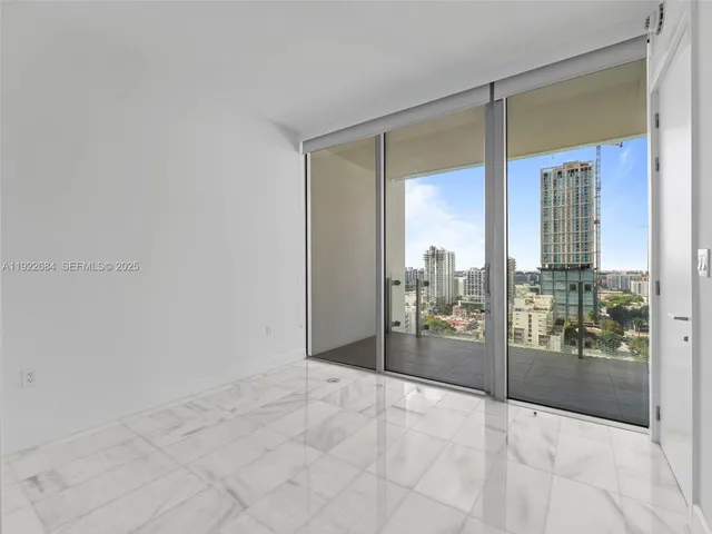 a view of a big room with windows and view of bathroom