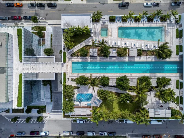 an aerial view of a house with a yard and lake view