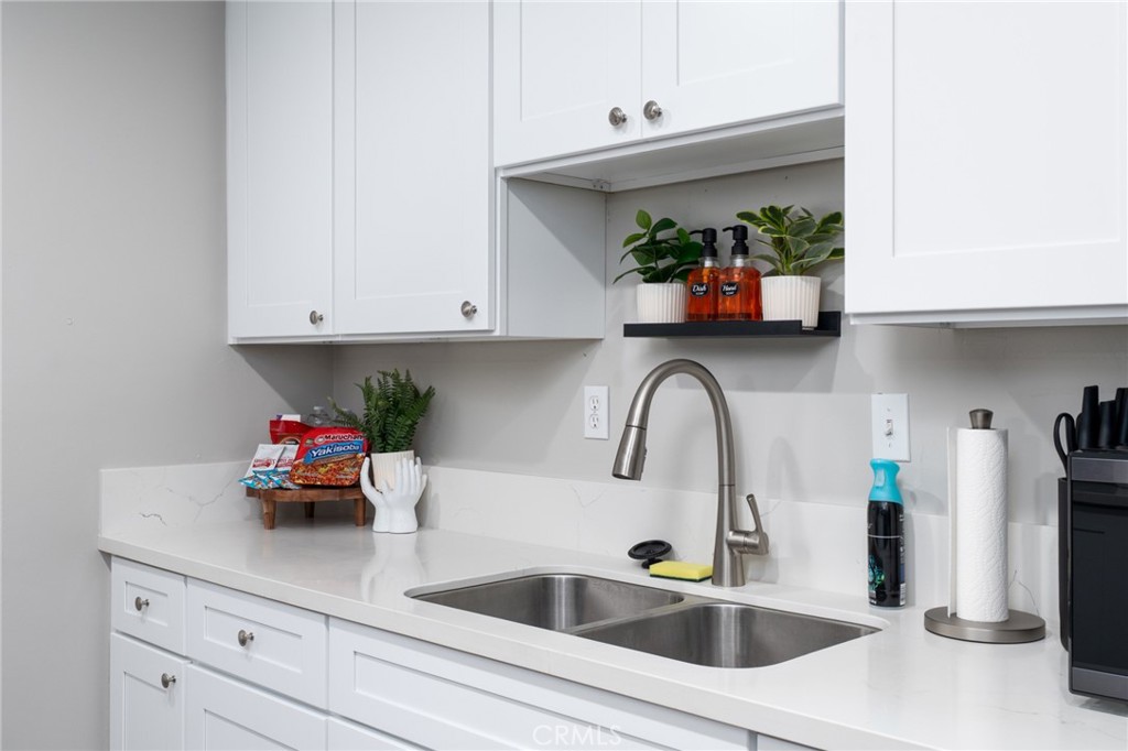 716 Orange Street Riverside, CA 92501 - Photo 11 of 28 a kitchen with stainless steel appliances white cabinets a sink and dishwasher