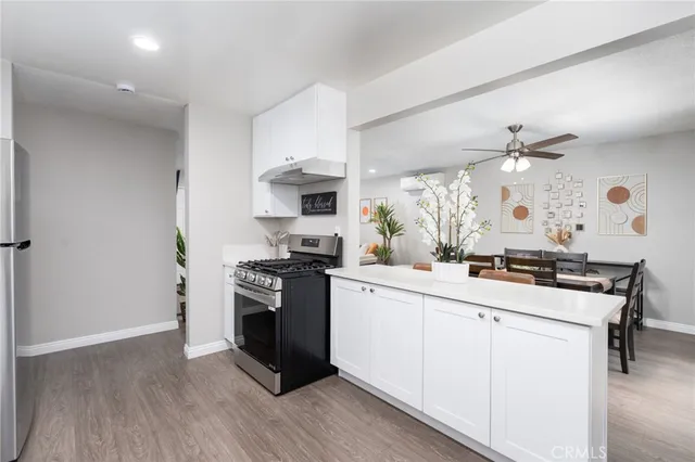 a kitchen with white cabinets and appliances