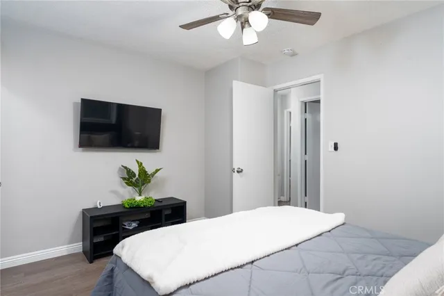 a bedroom with a bed and a flat screen tv