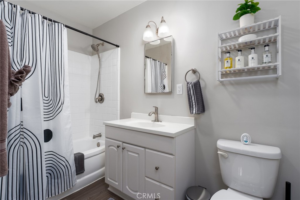 716 Orange Street Riverside, CA 92501 - Photo 15 of 28 a bathroom with a toilet sink and mirror