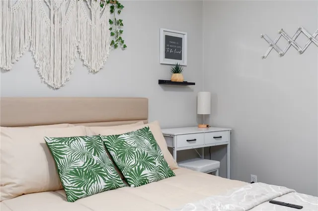 a bedroom with a bed and ceiling fan