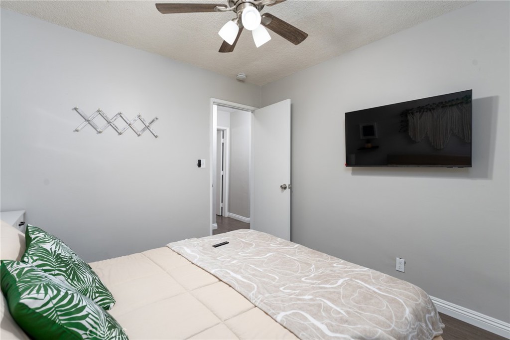 716 Orange Street Riverside, CA 92501 - Photo 20 of 28 a bedroom with a bed and a flat screen tv
