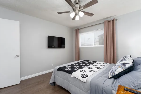 a bedroom with a large bed and a flat screen tv