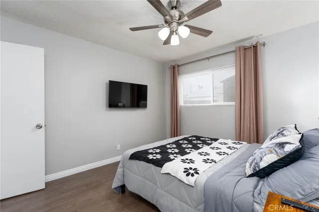 a bedroom with a large bed and a flat screen tv