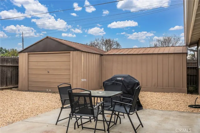 a backyard of a house with table and chairs