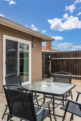 a roof deck with table and chairs