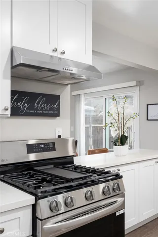a stove top oven sitting inside of a kitchen