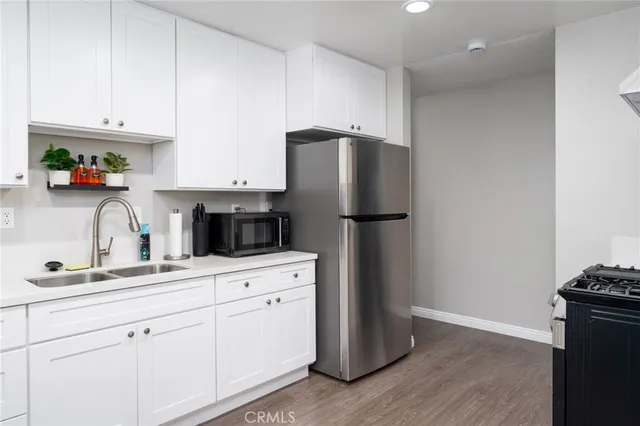 a kitchen with a refrigerator and cabinets