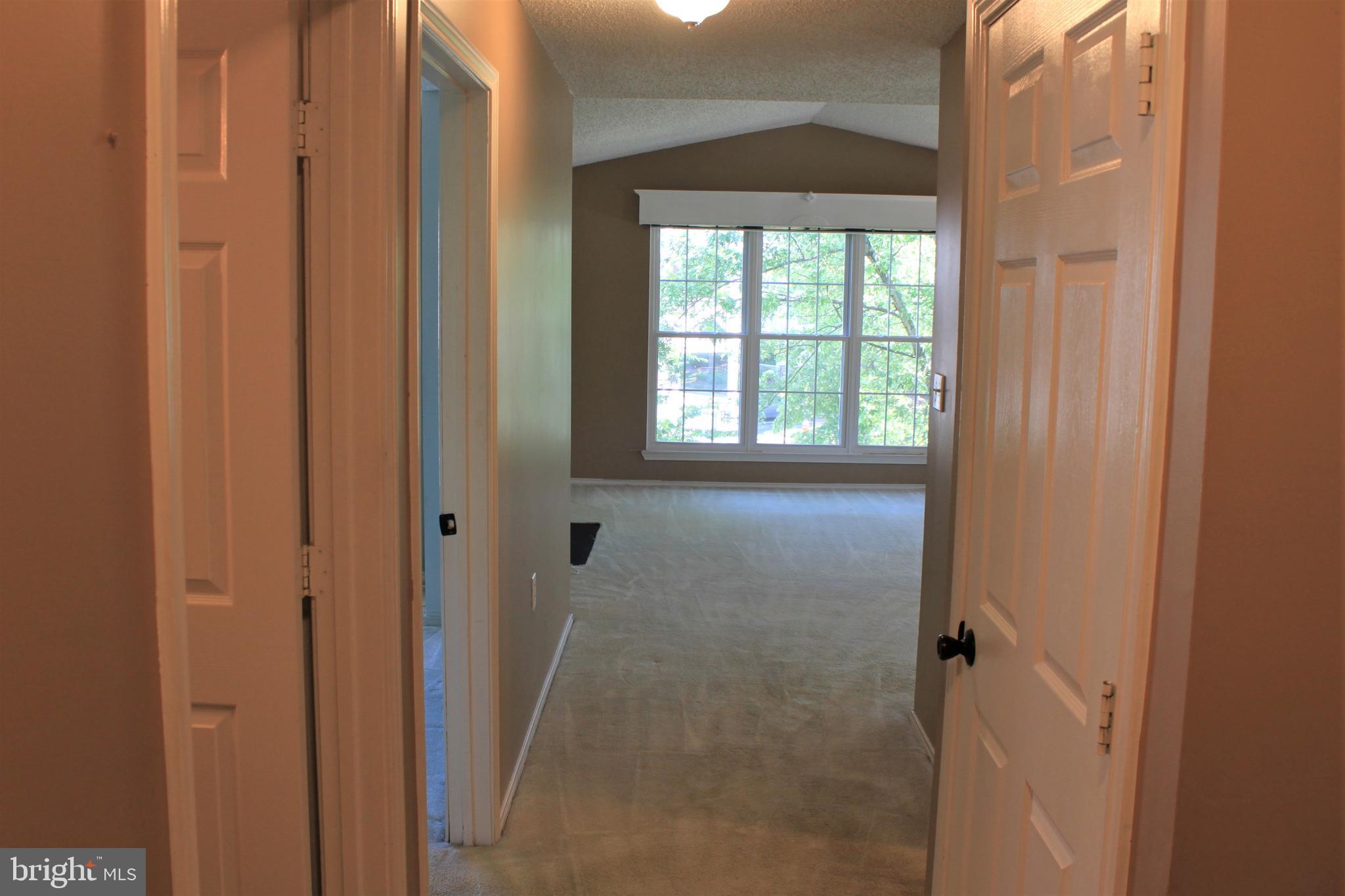 20952 Timber Ridge Terrace, Unit 302 Ashburn, VA 20147 - Photo 2 of 13 Foyer to family room