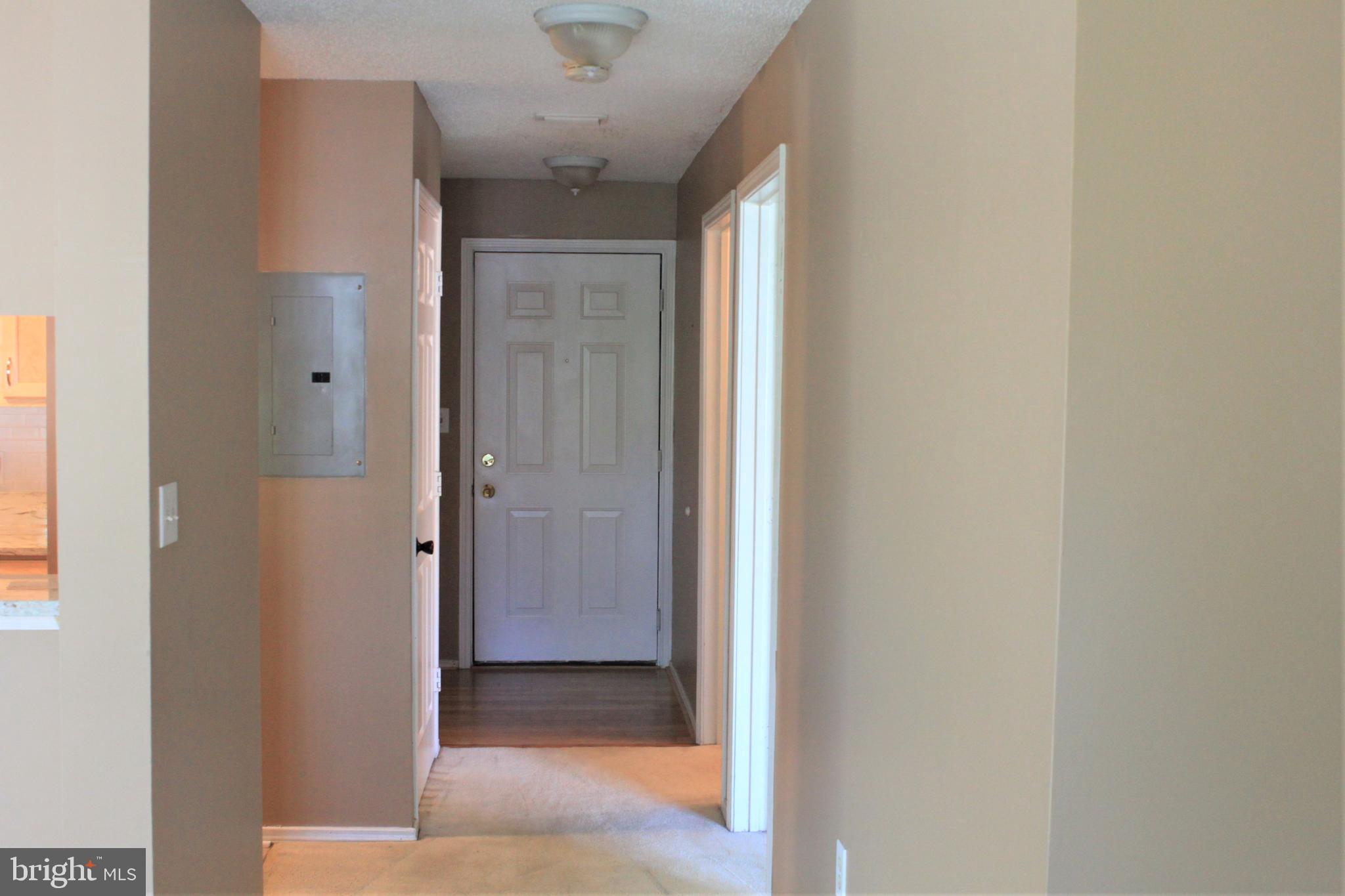 20952 Timber Ridge Terrace, Unit 302 Ashburn, VA 20147 - Photo 3 of 13 Family room to foyer