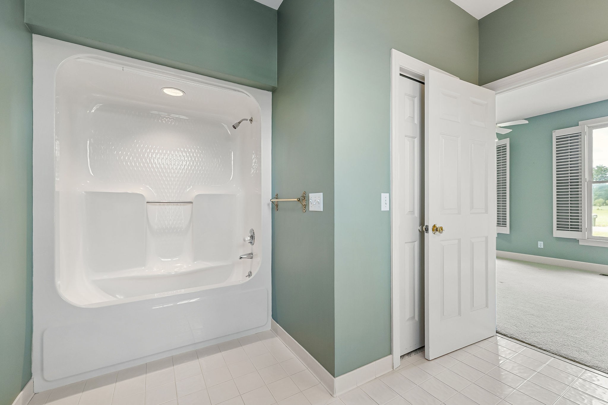 328 Riley Avenue Smithville, TN 37166 - Photo 23 of 40 a bathroom with a glass shower door and a bathtub