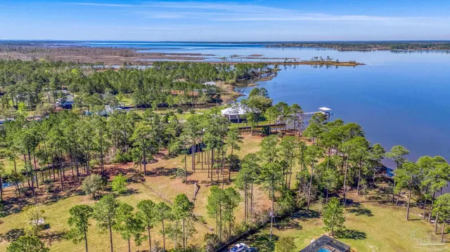 a view of a yard with wooden fence