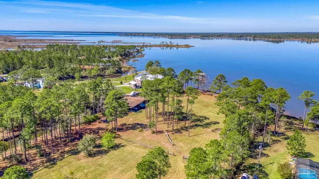 a view of a swimming pool with a patio and a yard