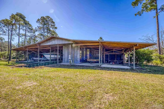 a house view with swimming pool in front of the house
